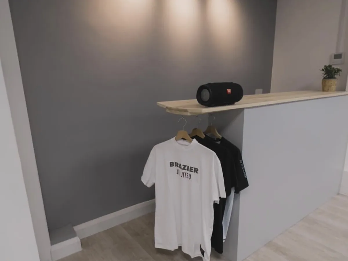 Brazier Jiu Jitsu reception with academy clothing on display